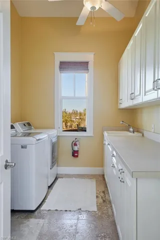 Laundry room with cabinets and sink