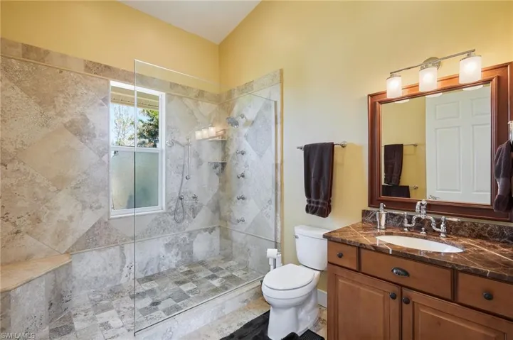 Bathroom #2 with tiled shower and seamless glass.