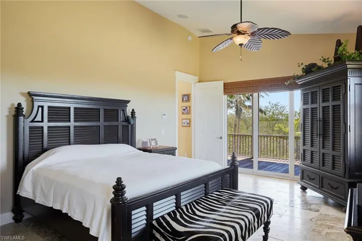 Primary bedroom with sliders to screened balcony