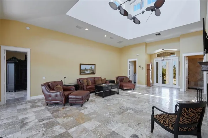 Living area with soaring ceilings looking toward the front door.