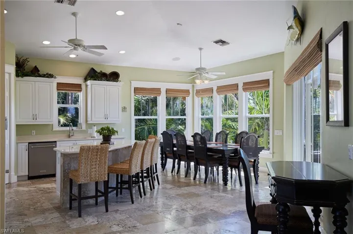 Kitchen featuring oversized bar with seating and windows galore!