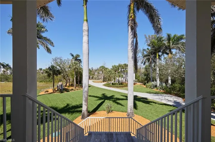 View of front yard, guest house and long driveway from the front porch of the main house.