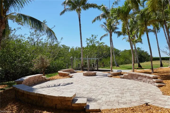 Beautiful paver patio area with ample seating and natural wood firepit!!