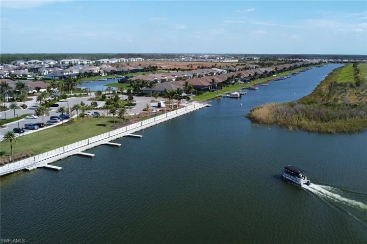 Birds eye view of property with a water view