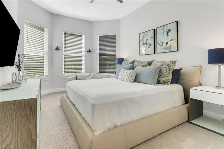 Bedroom featuring light carpet and ceiling fan
