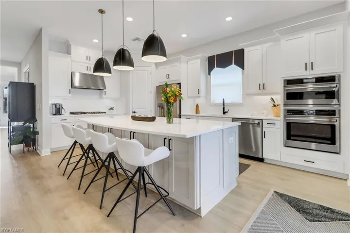 Kitchen with white cabinetry, a center island, and stainless steel appliances