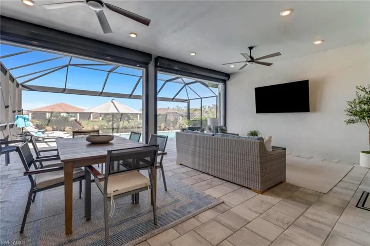 View of patio / terrace featuring a lanai, outdoor lounge area, and ceiling fan