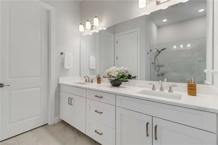 Bathroom featuring vanity and an enclosed shower