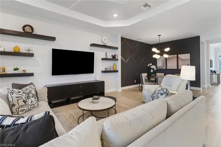 Living room with light hardwood / wood-style flooring and a chandelier