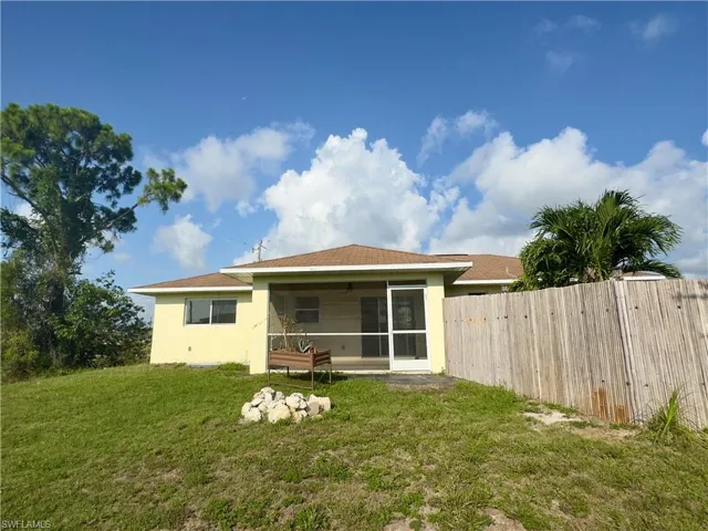 Back of property with a yard