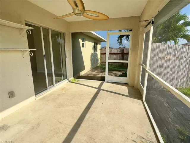Unfurnished sunroom with ceiling fan