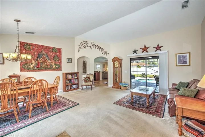 Living room with an inviting chandelier and carpet