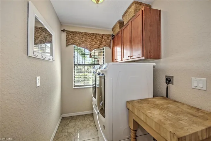 Laundry room featuring washer and dryer and cabinets