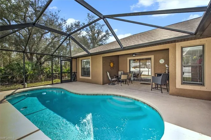 View of pool featuring a lanai, a patio, and ceiling fan