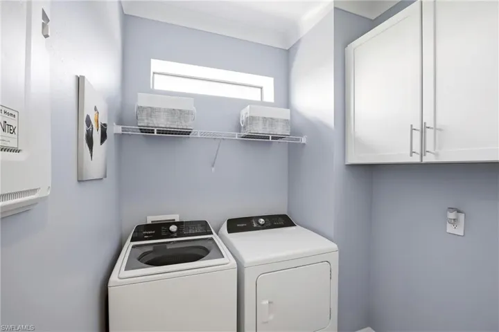 Laundry room featuring cabinet space and washer and dryer