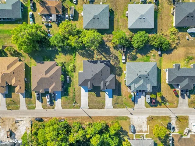 Aerial view of property's location featuring nearby suburban area