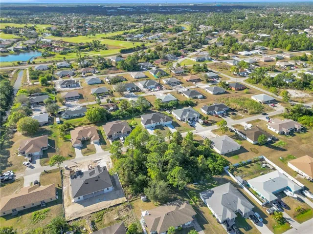 Aerial view of property's location featuring nearby suburban area