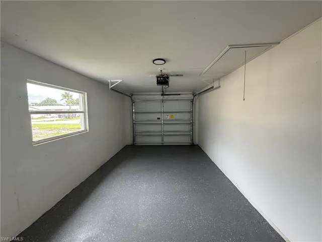 Garage featuring a garage door opener