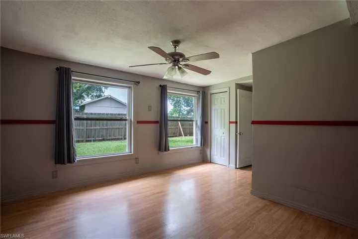 Spare room featuring ceiling fan, light hardwood / wood-style floors, and a textured ceiling