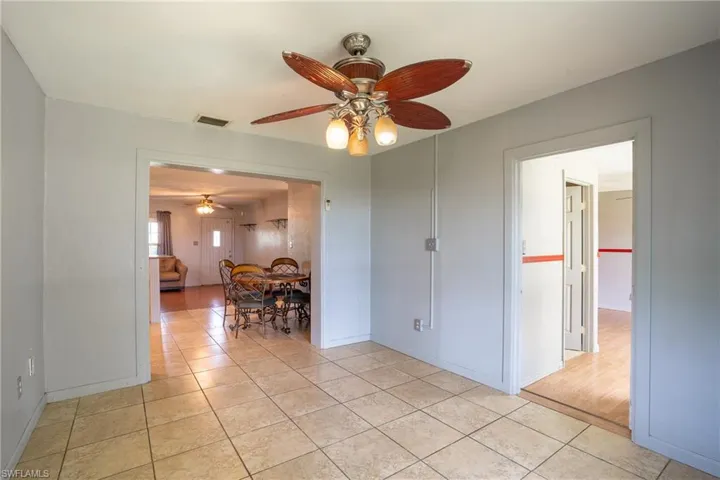 Unfurnished room with light tile flooring and ceiling fan