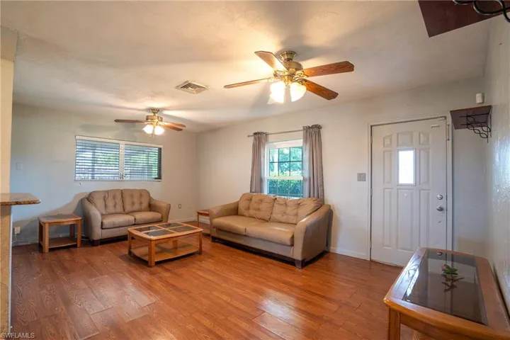 Living room featuring ceiling fan and hardwood / wood-style flooring