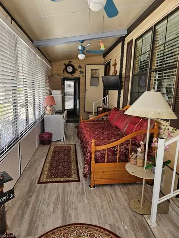 Sunroom / solarium featuring beam ceiling