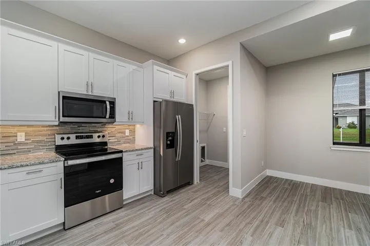 Entrance to laundry room with pocket door.