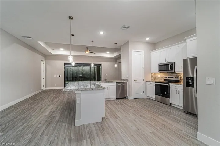 Kitchen with large island and pantry.