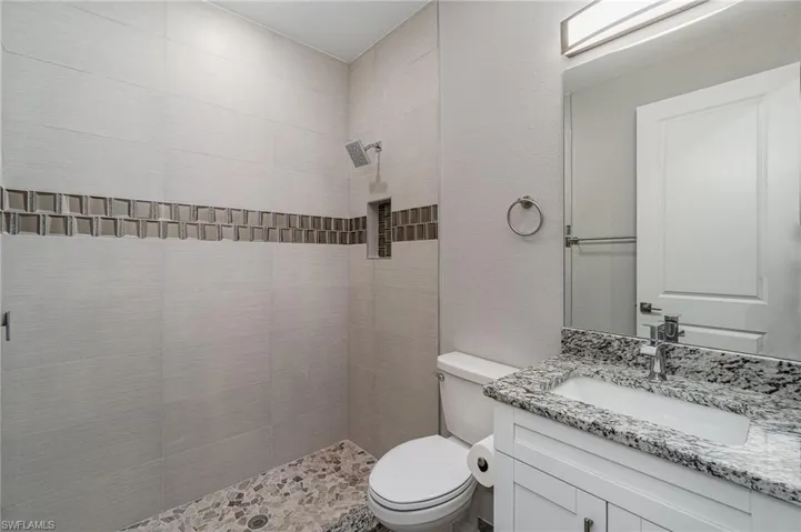 Guest bathroom with linen closet.