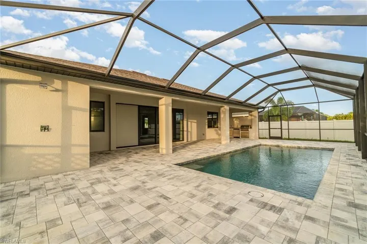 Large pool area with outdoor kitchen.