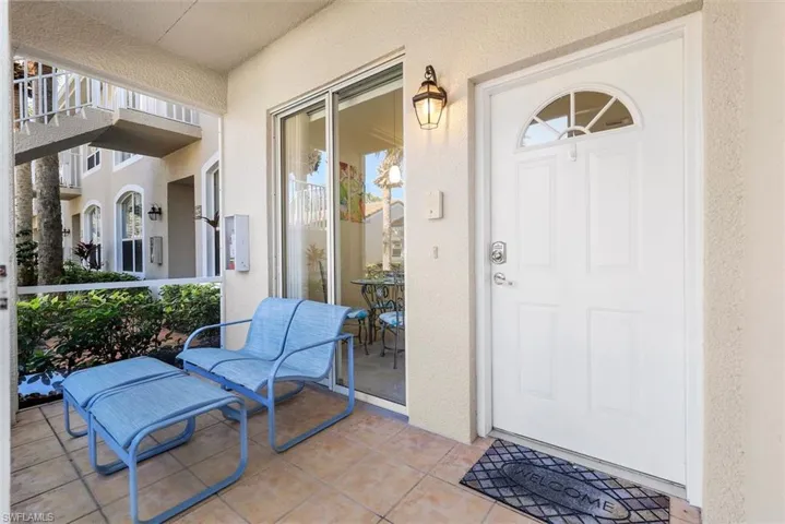 View of front screened in lanai with glass sliding doors which allows for refreshing cross breezes.