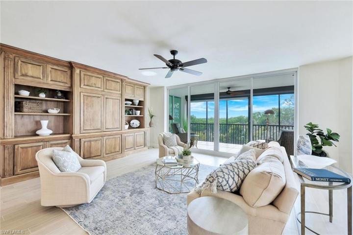 Living room with custom built in cabinets and Southern views over the treetops.