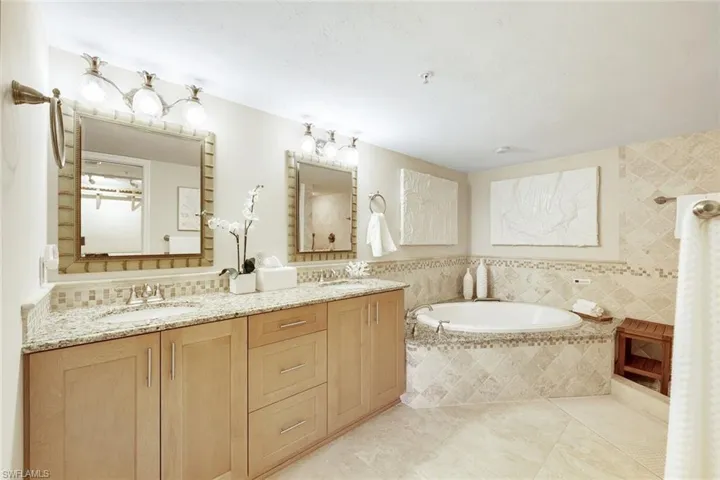 The primary bathroom features dual sinks, a soaking tub, and a separate walk in shower.