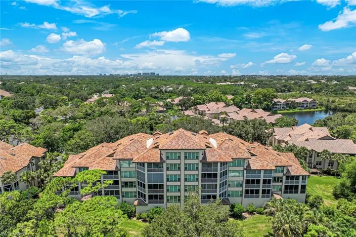 Aerial view of the building nestled among trees and nature preserves.