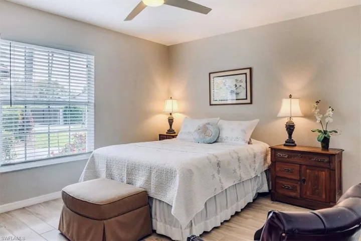 Bedroom with light wood-style floors and a ceiling fan