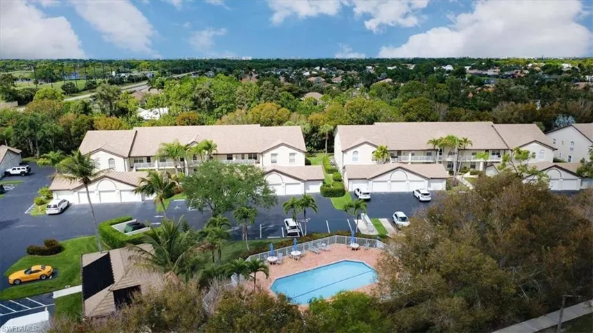 Aerial view of residential area featuring a tree filled landscape