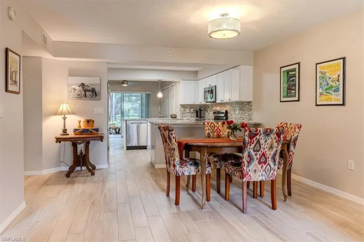 Dining space with light wood finished floors and baseboards