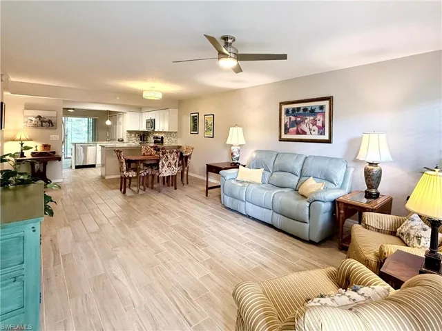 Living area with light wood-type flooring and ceiling fan