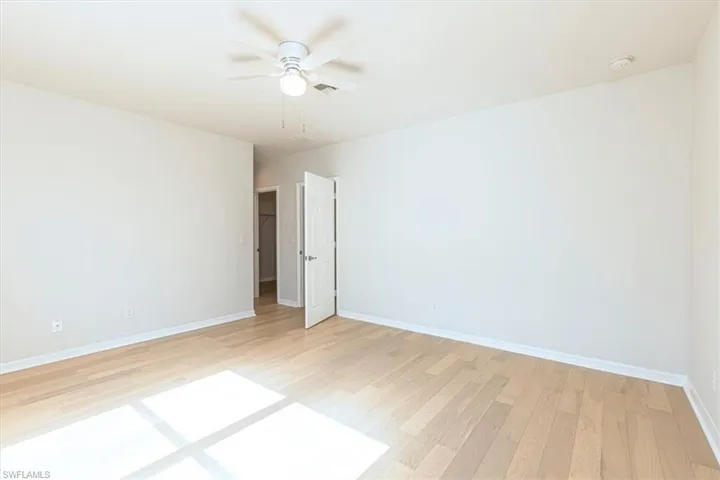 Spare room with light wood-style floors and ceiling fan