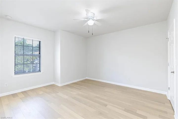Unfurnished room with ceiling fan and light wood-style floors