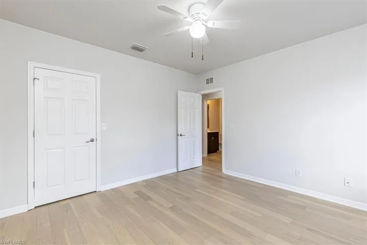 Unfurnished bedroom with a ceiling fan and light wood-type flooring