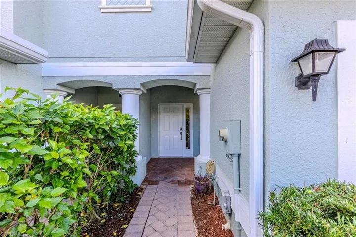 Property entrance featuring stucco siding