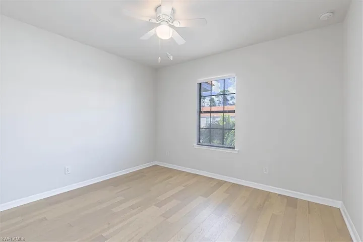 Empty room with light wood-style flooring and a ceiling fan