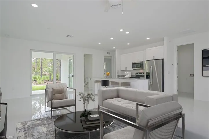Living room featuring sink and light tile patterned floors