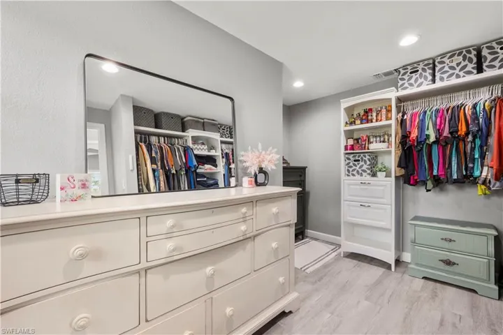 Spacious closet featuring light hardwood / wood-style flooring