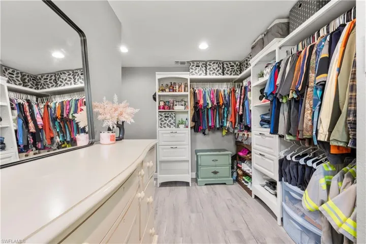 Spacious closet with light hardwood / wood-style floors