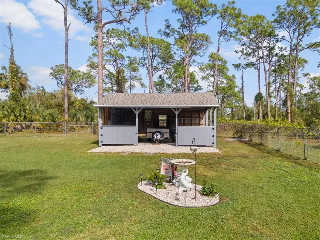 View of outbuilding with a lawn