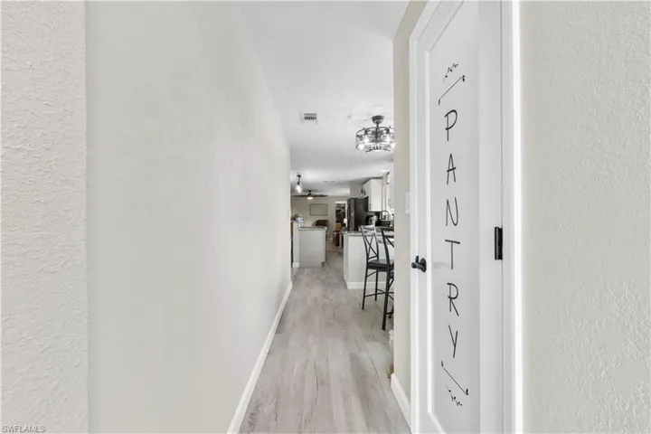 Hall with light hardwood / wood-style floors