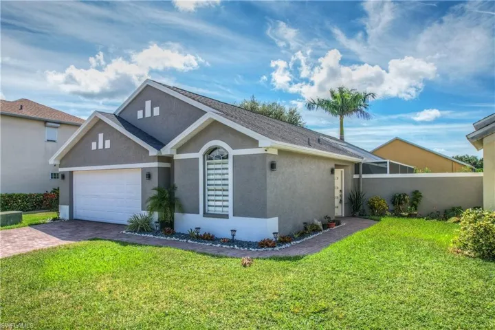 View of front of house with a garage and a front yard