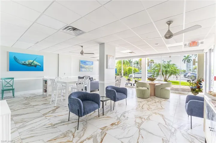 Common area featuring a drop ceiling and floor to ceiling windows